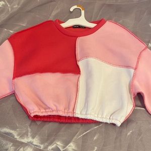 pink and white sweat shirt